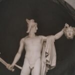 Marble statue of Perseus holding Medusa’s head and a sword, illustrating Greek mythology aegis-related symbolism