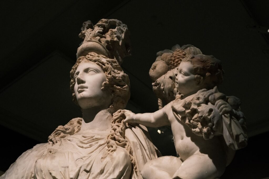 Ancient marble statue of the Roman goddess of dawn with a cherub in classical style