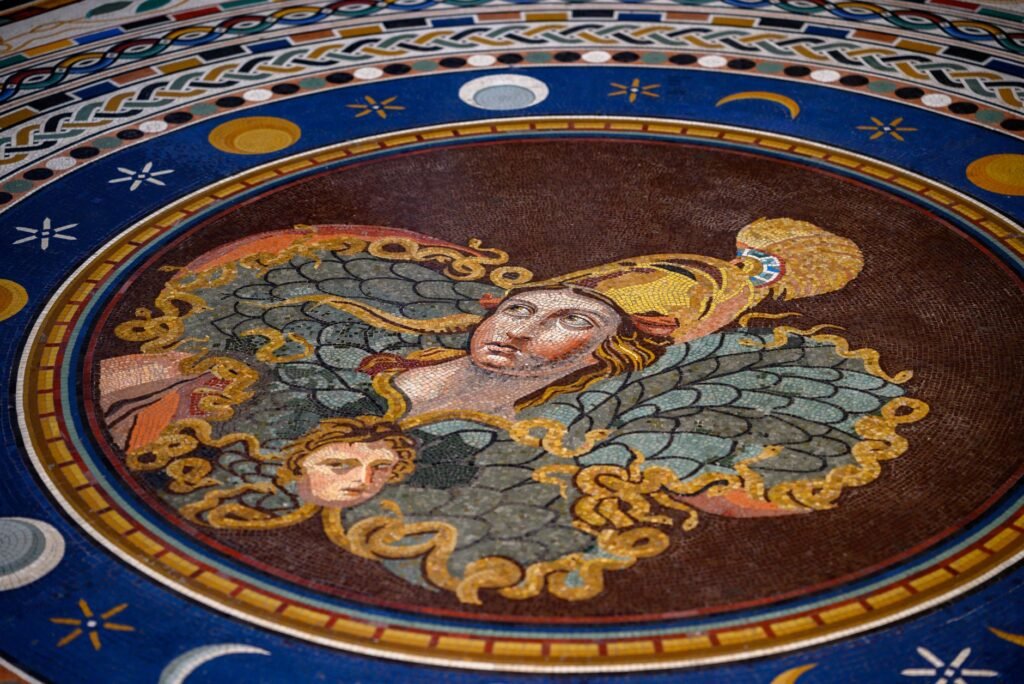 Intricate mosaic of an angelic figure with wings and a halo, set in detailed decorative patterns