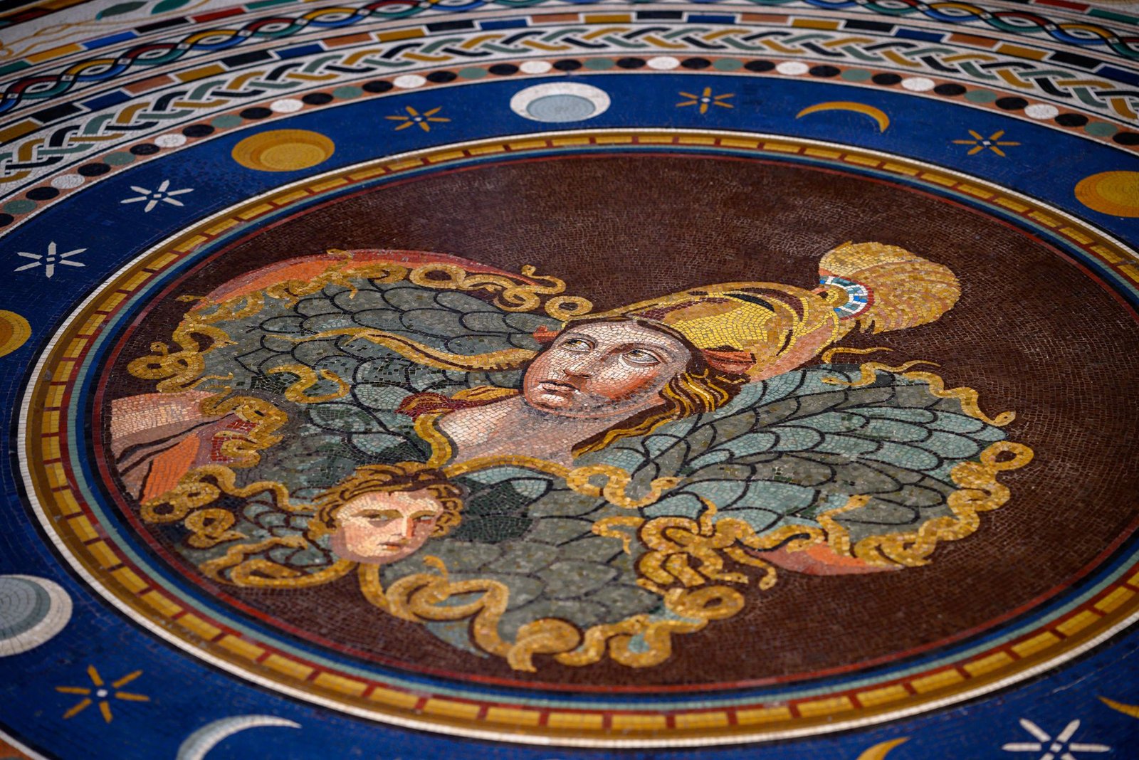 Intricate mosaic of an angelic figure with wings and a halo, set in detailed decorative patterns