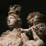 Ancient marble statue of Bellona, Roman goddess of war, with a cherub in classical style