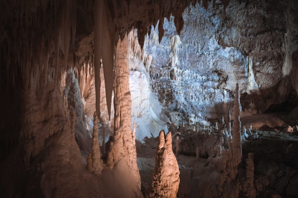 Limestone cave interior with stalactites and stalagmites, evoking Zeus’s birth in the Cretan cave