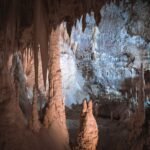 Limestone cave interior with stalactites and stalagmites, evoking Zeus’s birth in the Cretan cave