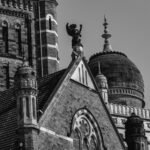Black and white photo of historic buildings with intricate domes and spires, evoking the Boundary Stone of Terminus