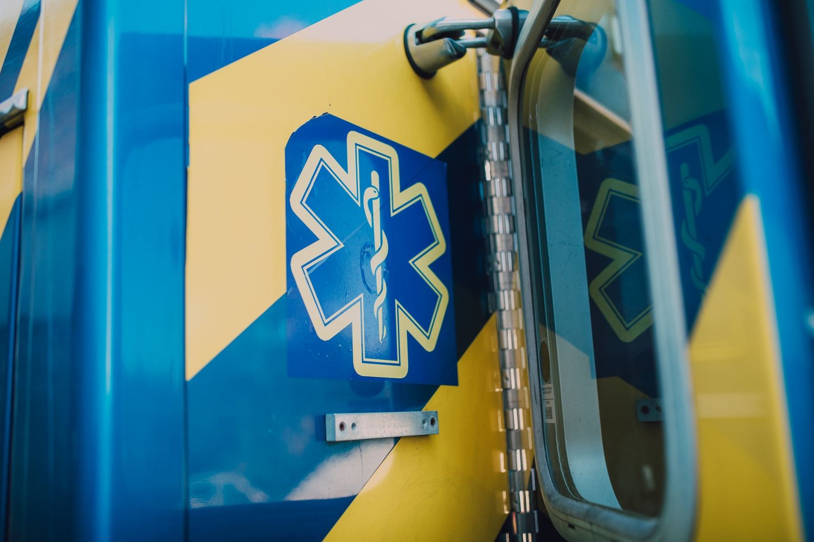 Medical emergency symbol on the side of an ambulance, featuring a caduceus with wings and two snakes
