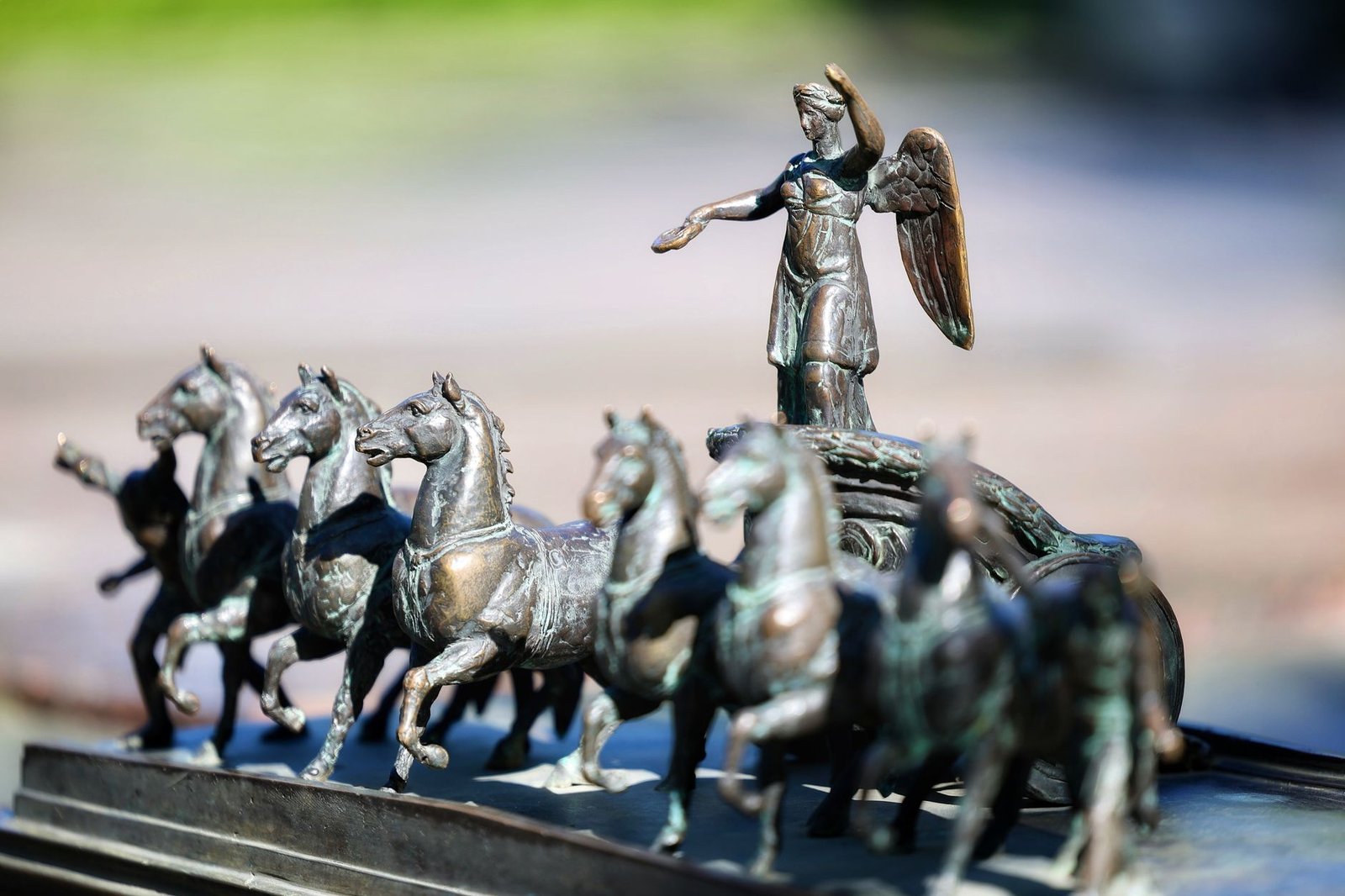 Bronze chariot sculpture with horses and a warrior figure in close-up, evoking Cliodhna and Irish mythology figures