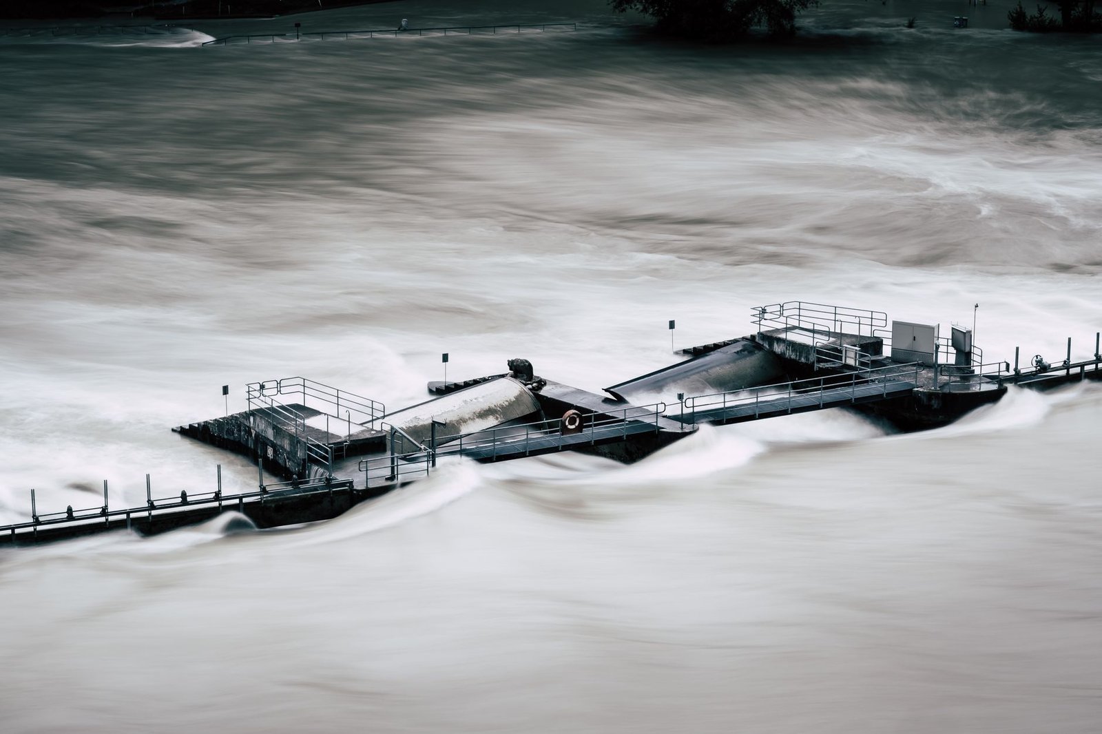 Flooded pier submerged in turbulent storm water, evoking Deucalion’s flood myth