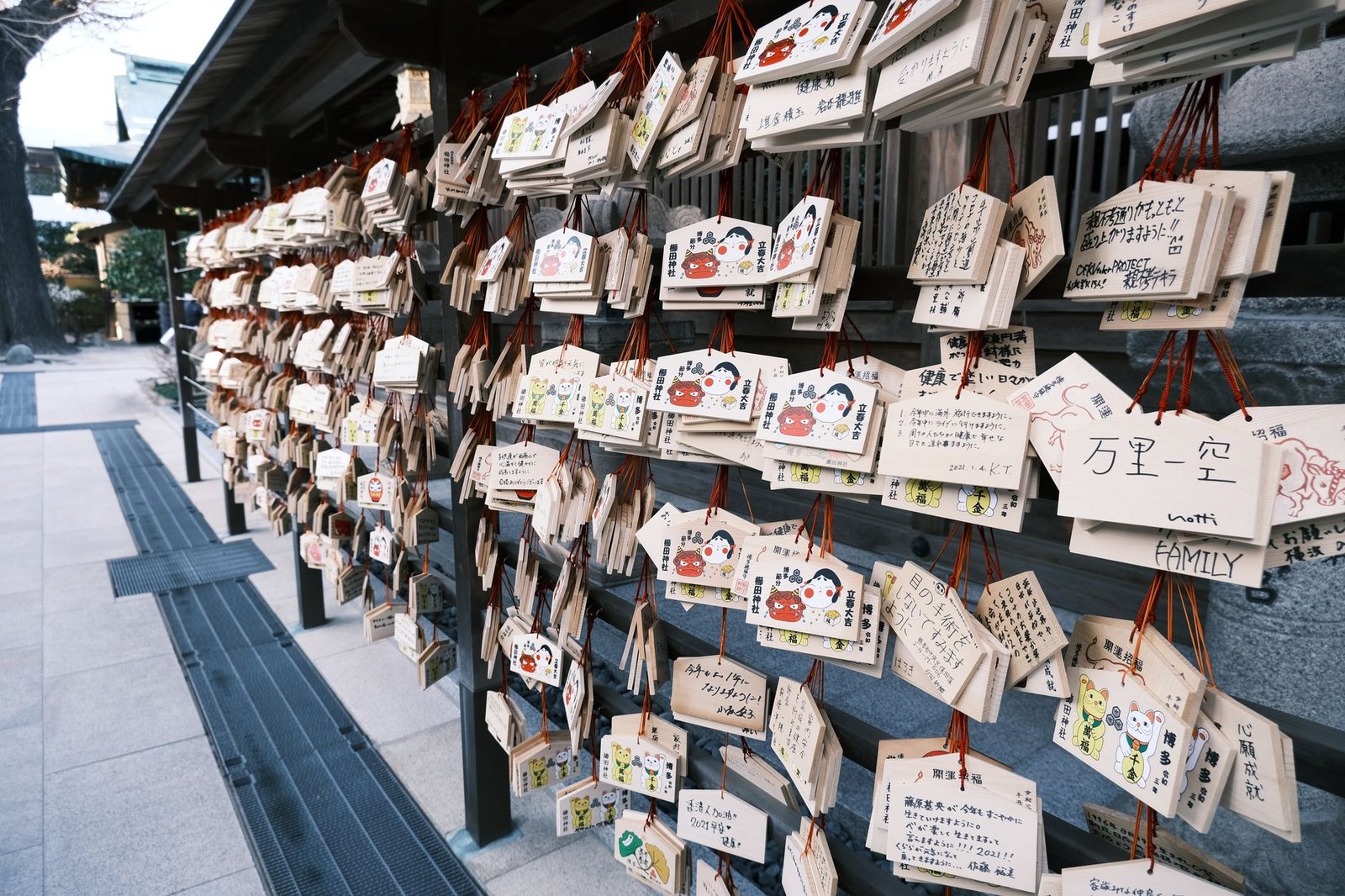 Traditional Japanese ema prayer plaques hanging at a Shinto shrine