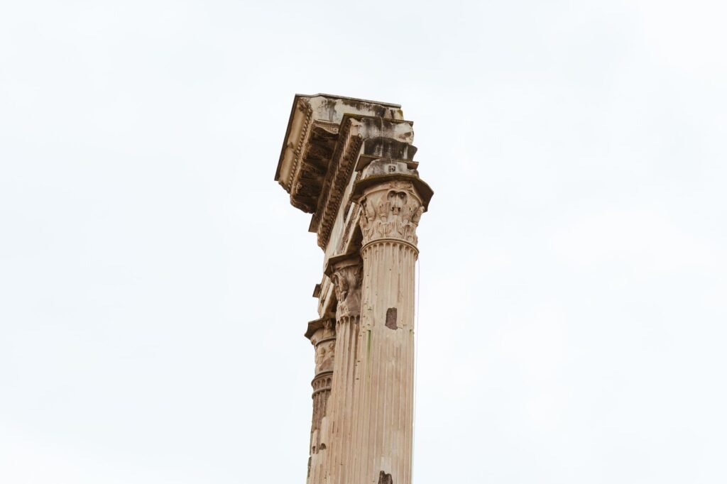 Ancient Roman column ruins beneath a clear sky, evoking the Roman fasces symbol’s historical setting