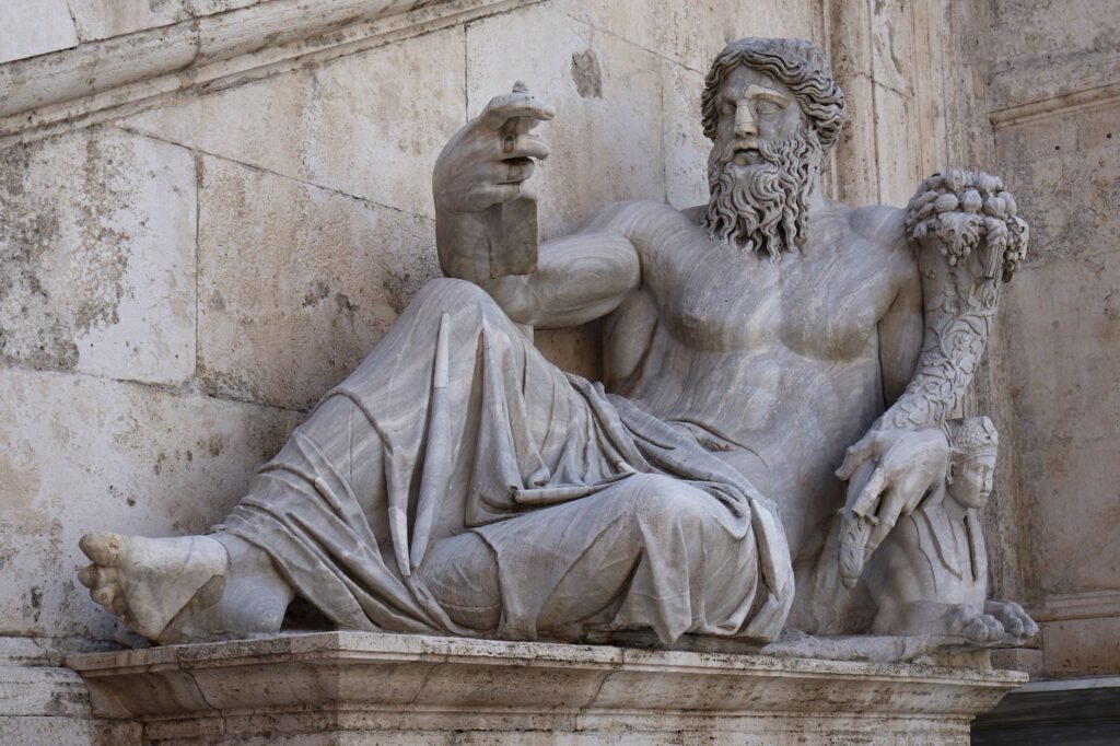 Ancient marble statue of a reclining bearded man with a lion beside him, representing Faunus, Roman god of nature and fertili