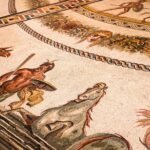 Ancient Roman mosaic showing mythological figures beside horses in a detailed floor scene