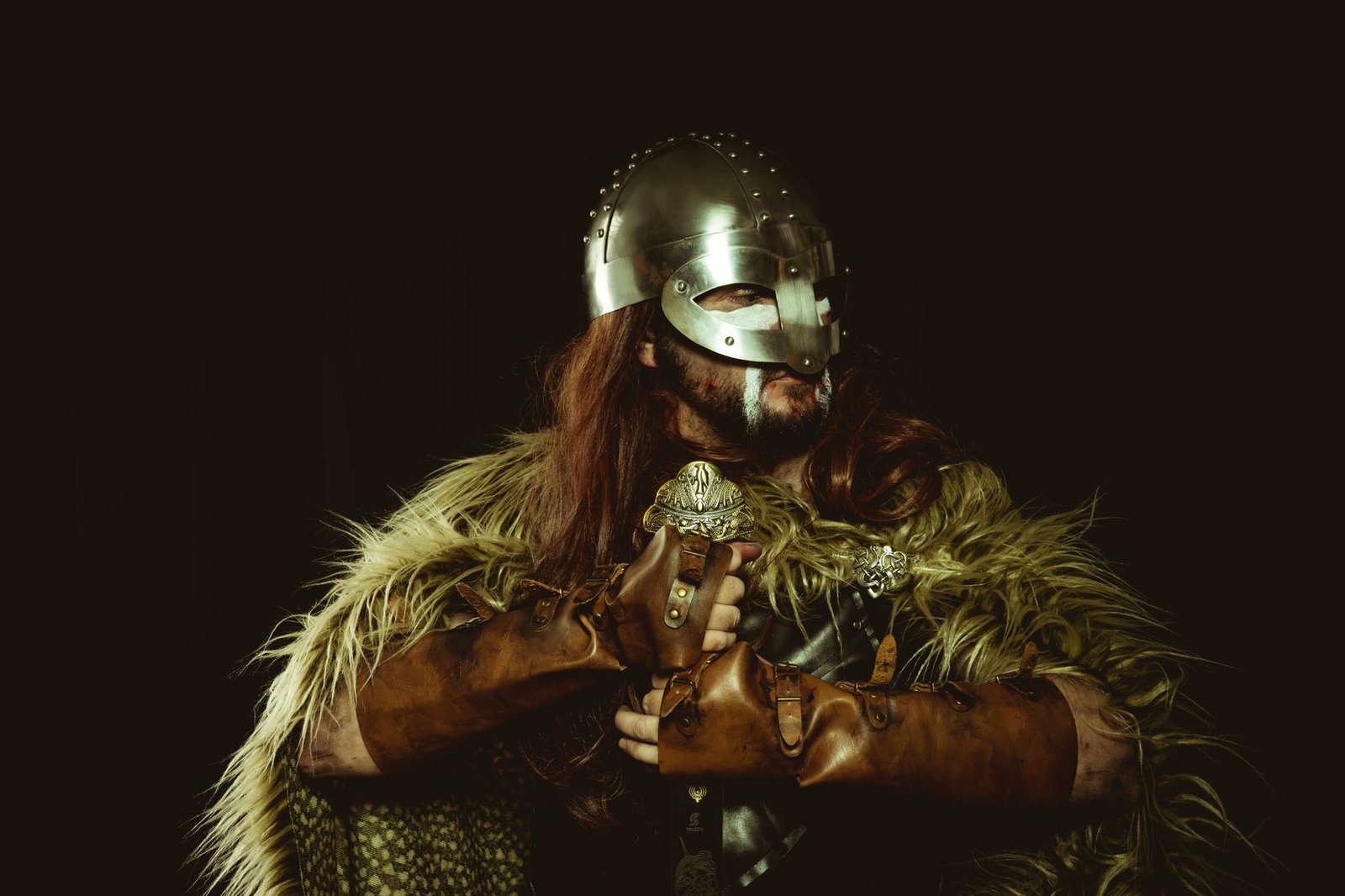 Medieval Norse warrior with sword and fur cloak illustrating giants in Norse mythology