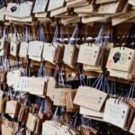 Wooden prayer plaques with handwritten wishes hanging at a Japanese Shinto shrine