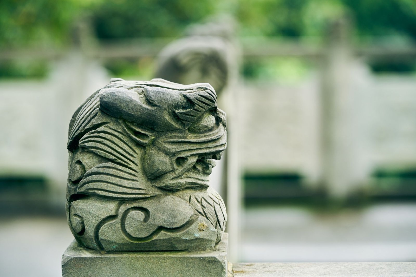 Close-up of a traditional stone dragon sculpture outdoors, representing a mythological creature in Irish mythology