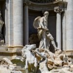 Trevi Fountain sculpture with Neptune on a shell chariot pulled by sea horses in Rome, Italy
