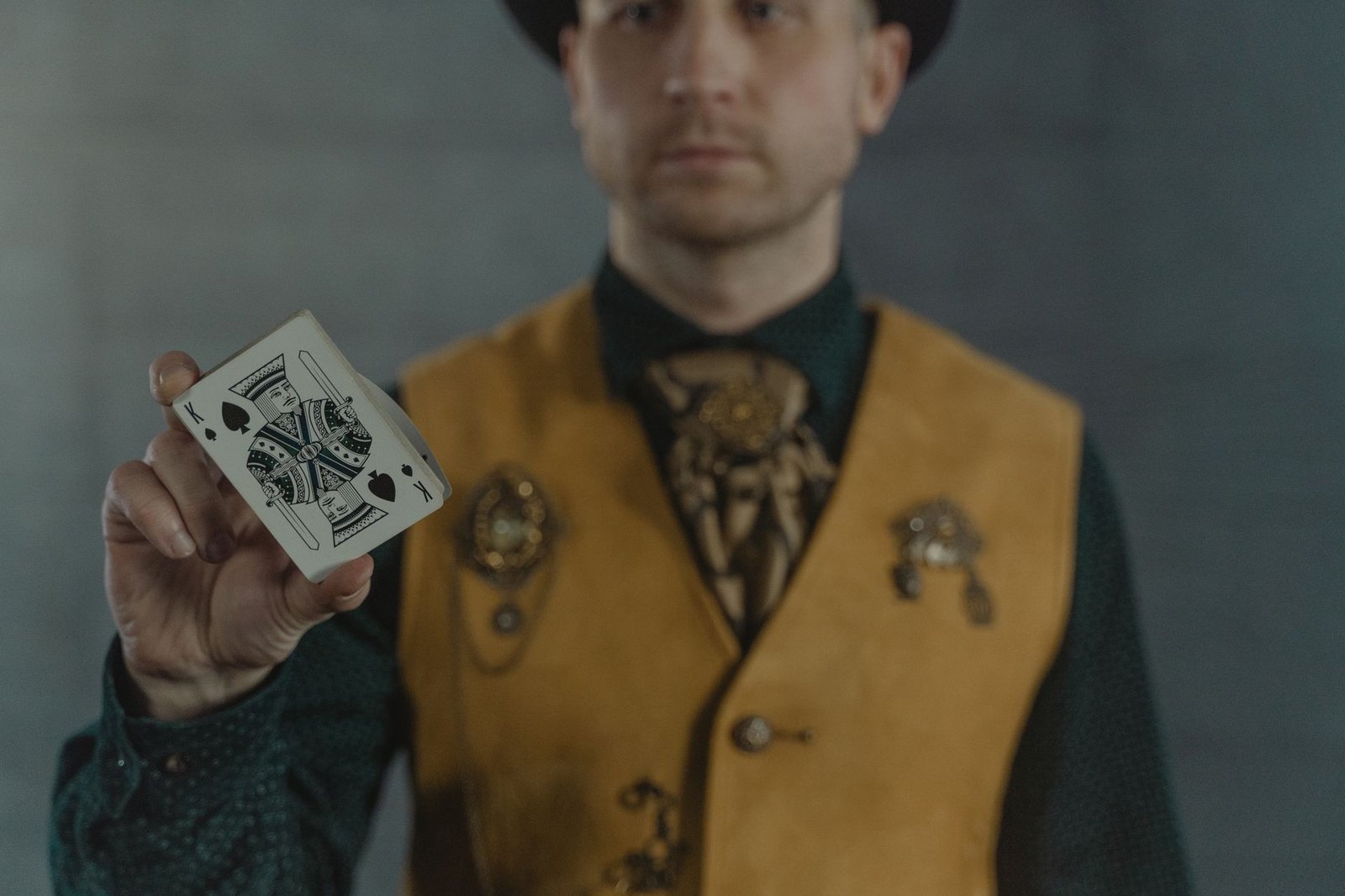 Magician in yellow vest and hat performing a trick, echoing Thor being tricked by Utgard-Loki