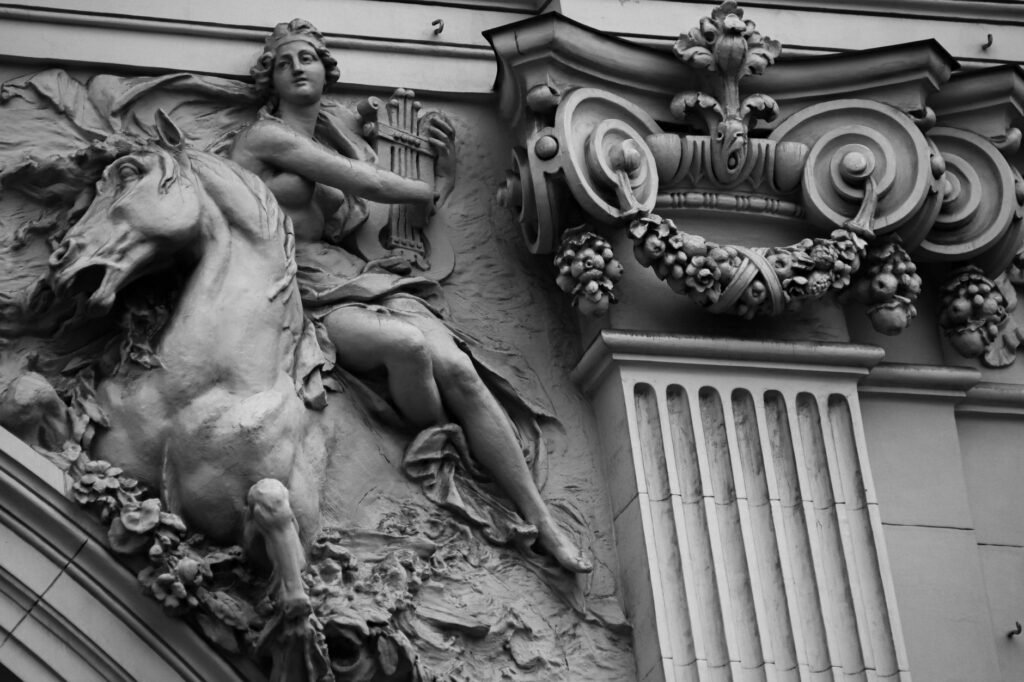 Black and white architectural relief of a horse and rider beside an ornate column, depicting the Roman goddess Luna