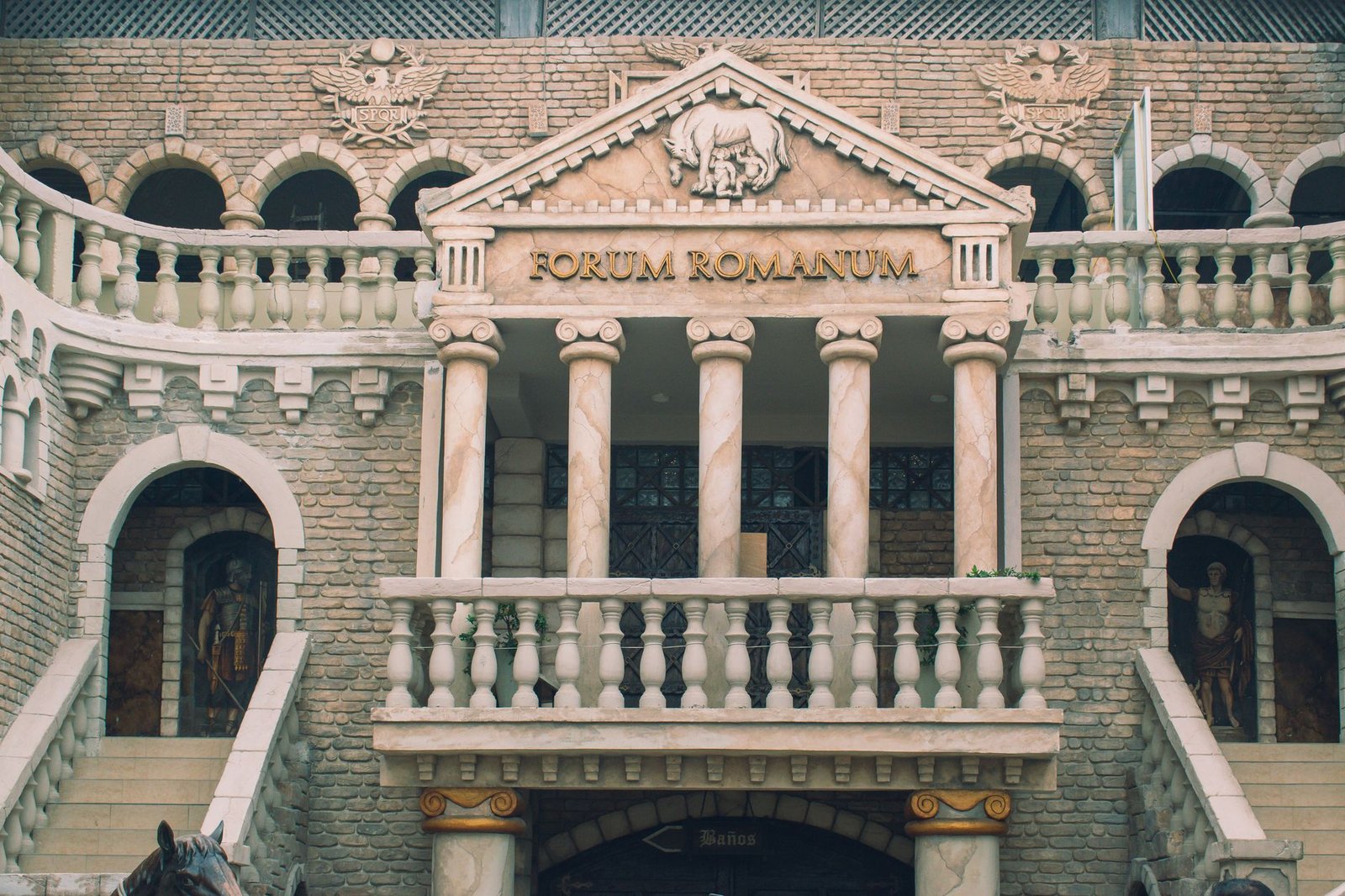 Facade of a Roman Forum-themed building with classical columns and ornate stonework