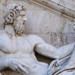 Classical marble statue of a bearded man holding a cornucopia, representing the Roman god Mars