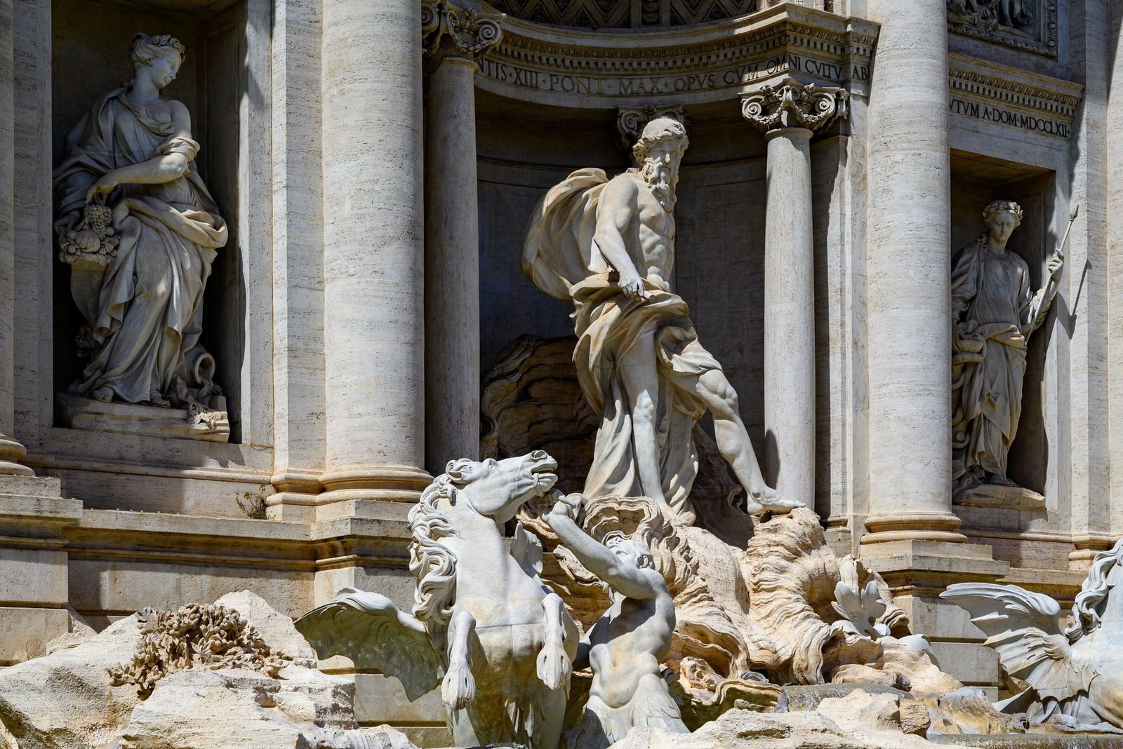 Statue of Mercury among marble figures at the Trevi Fountain in Rome, Italy