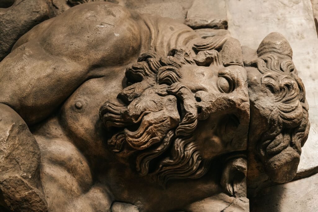 Close-up of an ancient stone sculpture of a bearded Mucius Scaevola, facing forward in Roman legend style