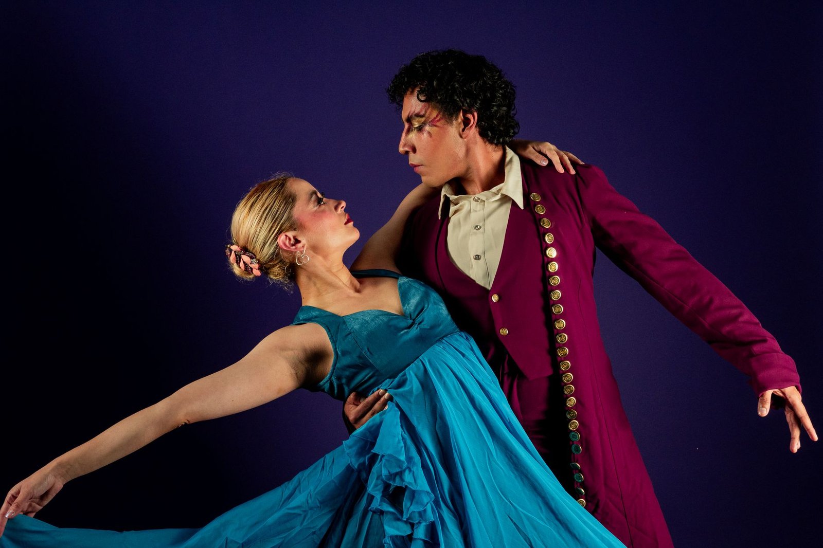 Male and female ballet dancers on stage in an elegant pose, evoking Orpheus and Eurydice