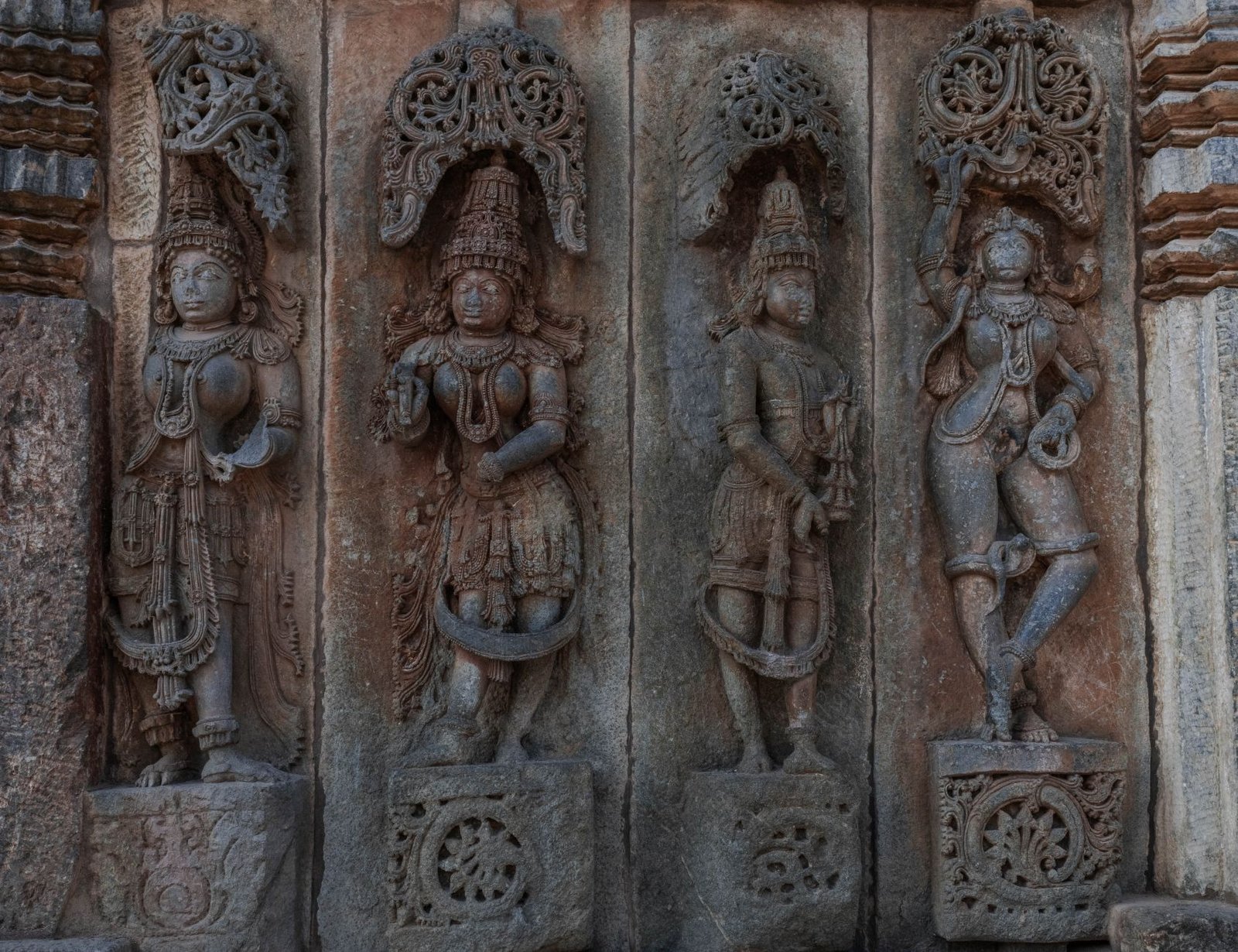 Ancient temple carvings of deities, illustrating primordial deities and Titans in mythological contrast