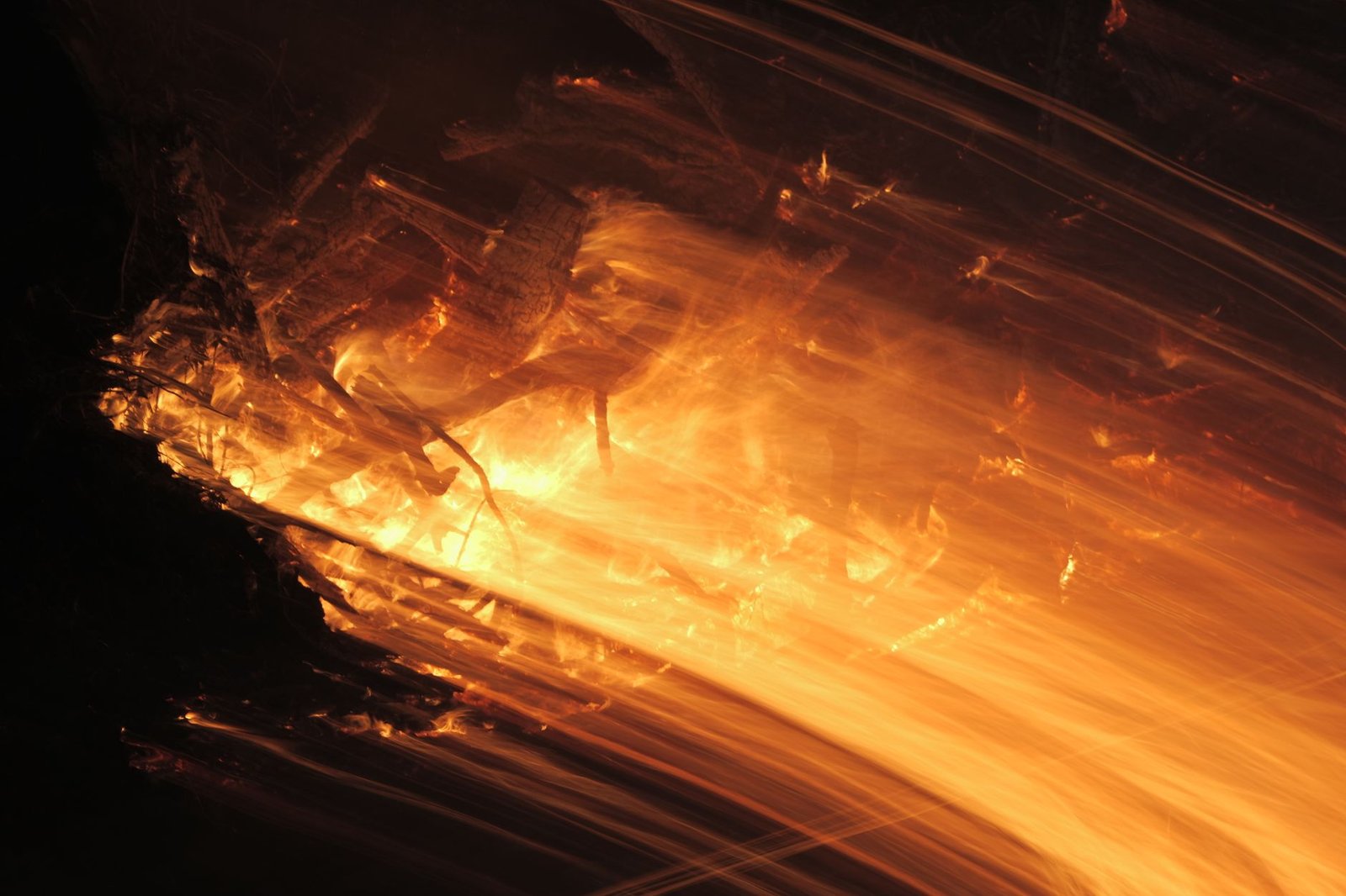 Bright orange sparks fly from metal grinding, suggesting Prometheus theft of fire.