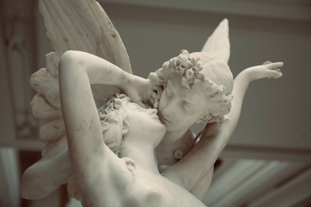 Classical marble sculpture of Psyche embracing Eros in an intimate pose, their faces close together