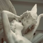Classical marble sculpture of Psyche and Cupid embracing in an intimate close-up