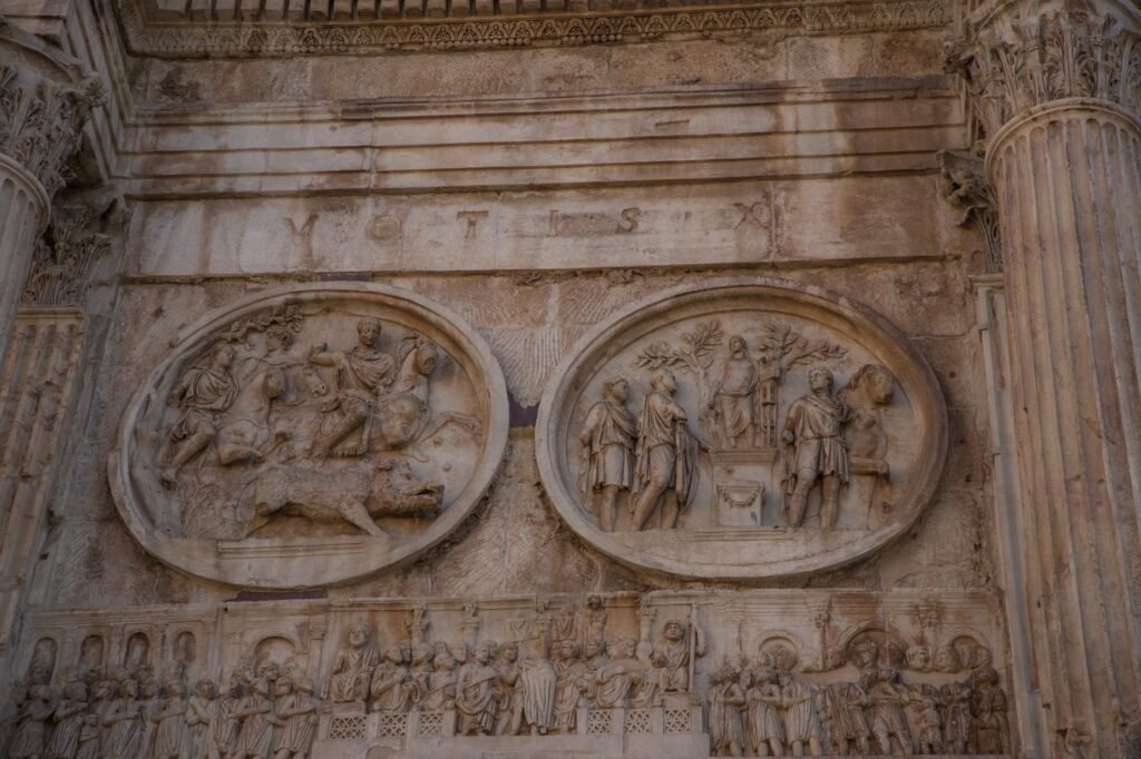 Ancient Roman stone relief of Romulus ascending to become Quirinus, carved on a marble wall with historical scenes