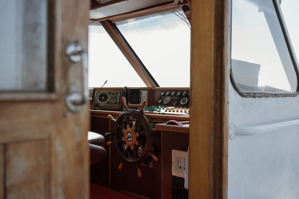 Wooden boat steering cabin with navigation instruments and a rudder, symbolizing Fortuna’s control of fate