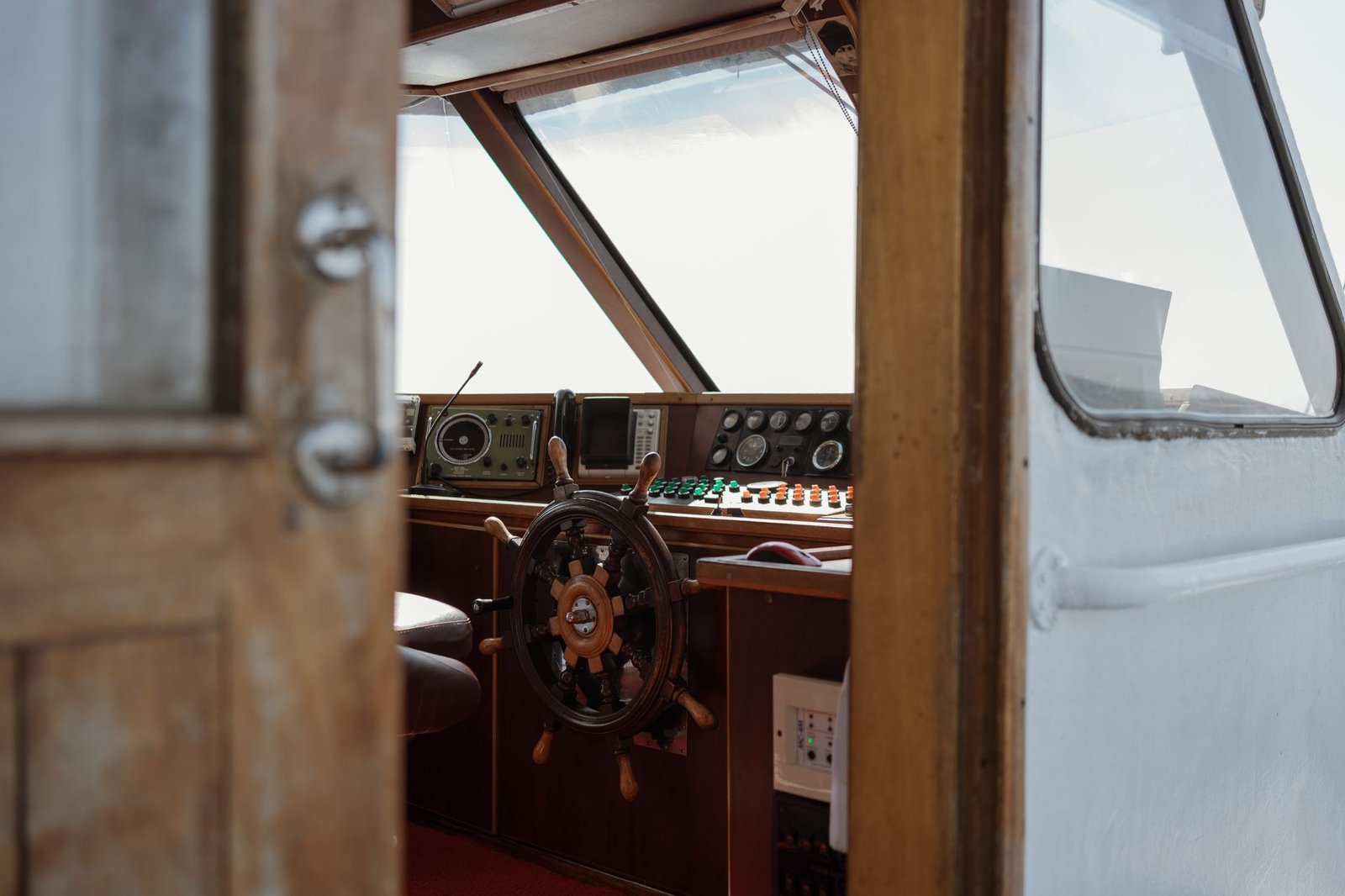 Wooden boat steering cabin with navigation instruments and a rudder, symbolizing Fortuna’s control of fate