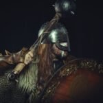 Viking warrior in traditional armor holding a spiked mace and shield