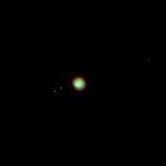 Jupiter with its four largest moons visible in a clear night sky