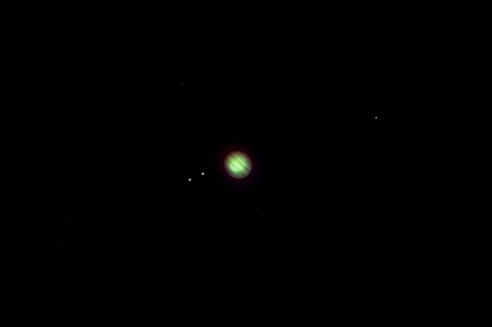 Jupiter with its four largest moons visible in a clear night sky