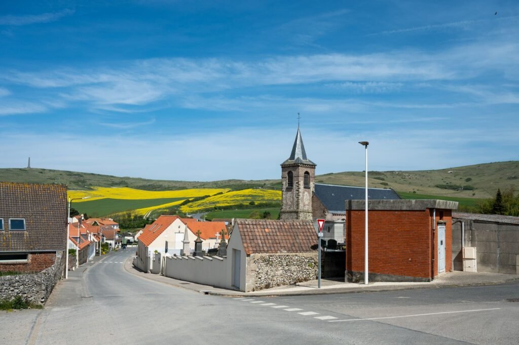 Small Irish village with a church tower and countryside under a blue sky, evoking Tochmarc Étaíne