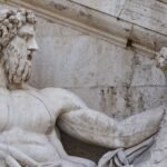 Marble statue of a muscular bearded man holding a cornucopia, evoking Typhon's rebellion against Zeus