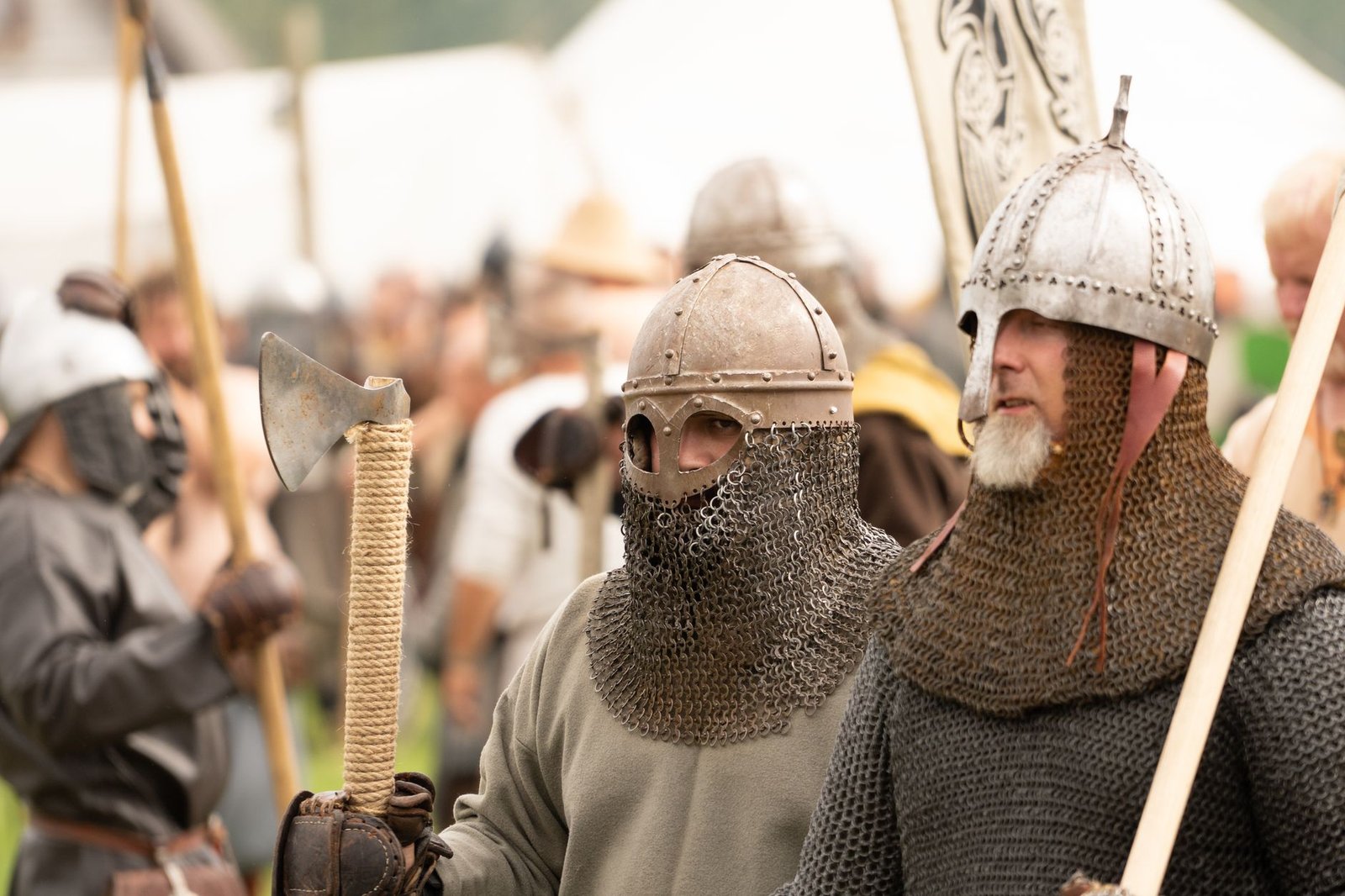 Viking reenactors in chainmail and helmets representing Viking Age symbols and modern Norse symbols differences