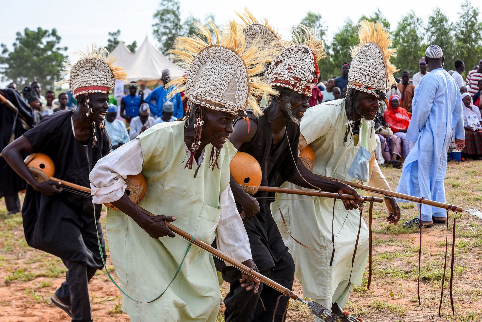 Traditional African dancers in cultural attire performing outdoors at a festival