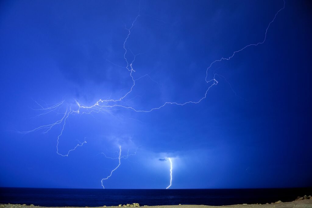 Lightning over the ocean at night, evoking the thunderbolt of Zeus in Greek mythology