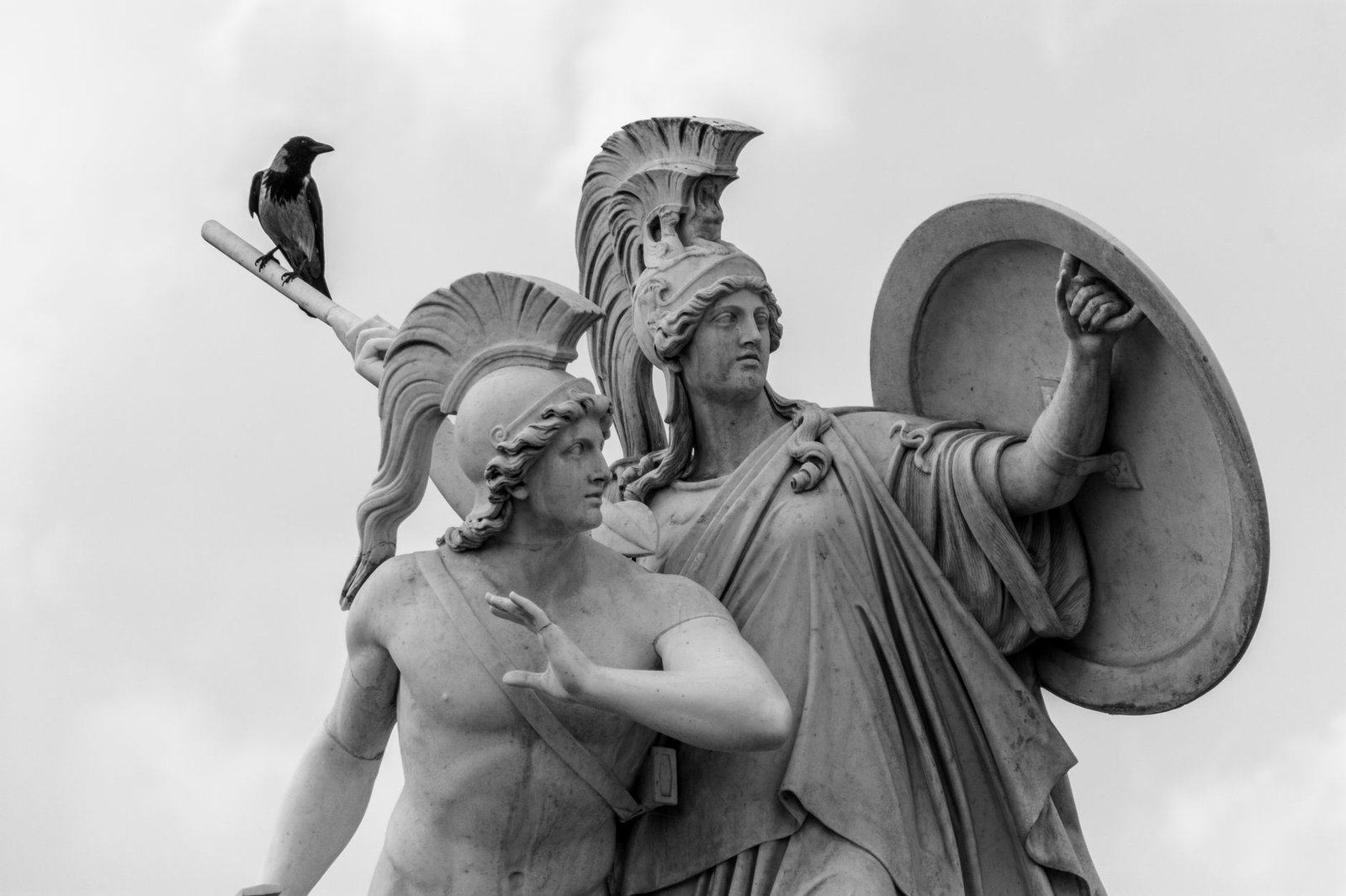 Classical statue of helmeted warriors with shield, evoking Athena in Greek mythology and ancient warfare