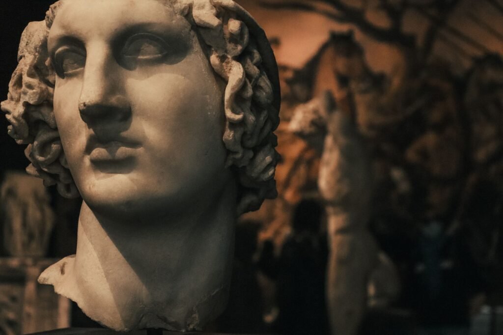 Classical marble statue head evoking Nyx in Greek mythology, goddess of night, in dim museum light