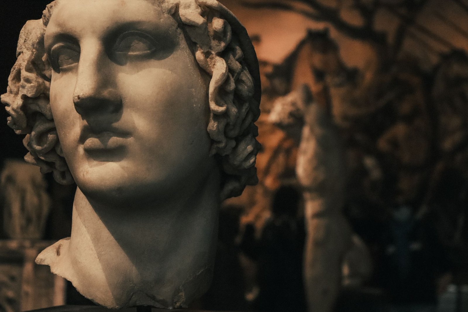 Classical marble statue head evoking Nyx in Greek mythology, goddess of night, in dim museum light