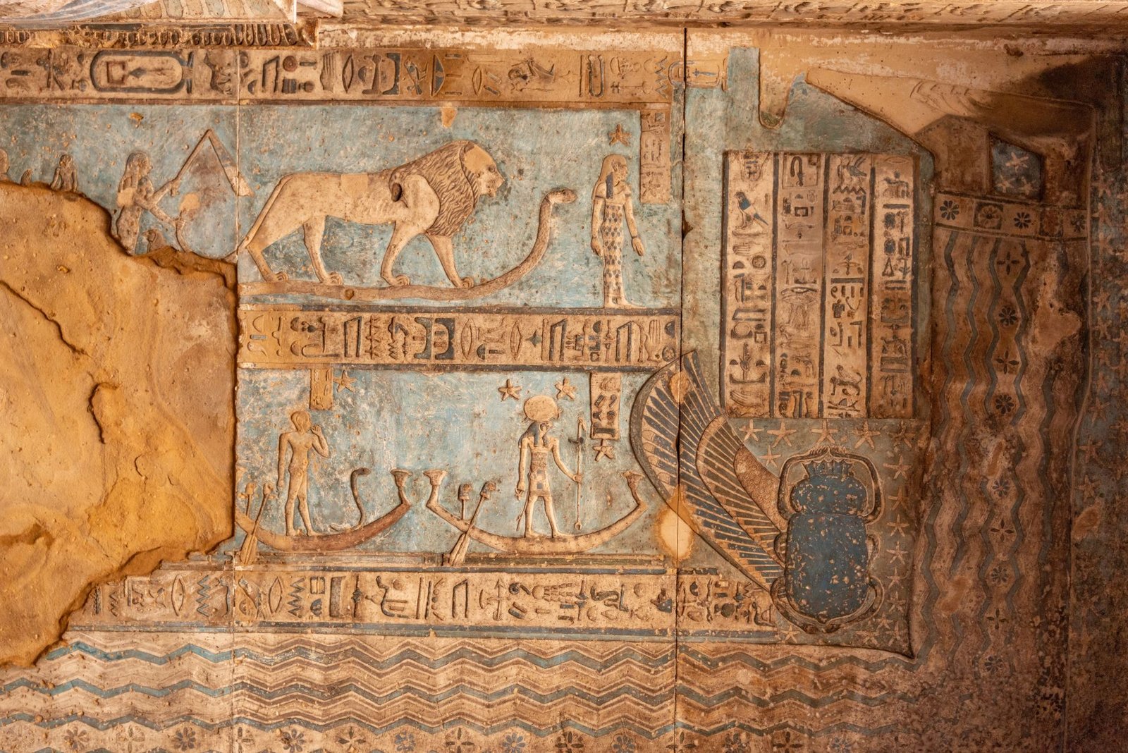 Ancient Egyptian wall painting with hieroglyphs and symbolic figures, likely depicting Seshat in Egyptian mythology