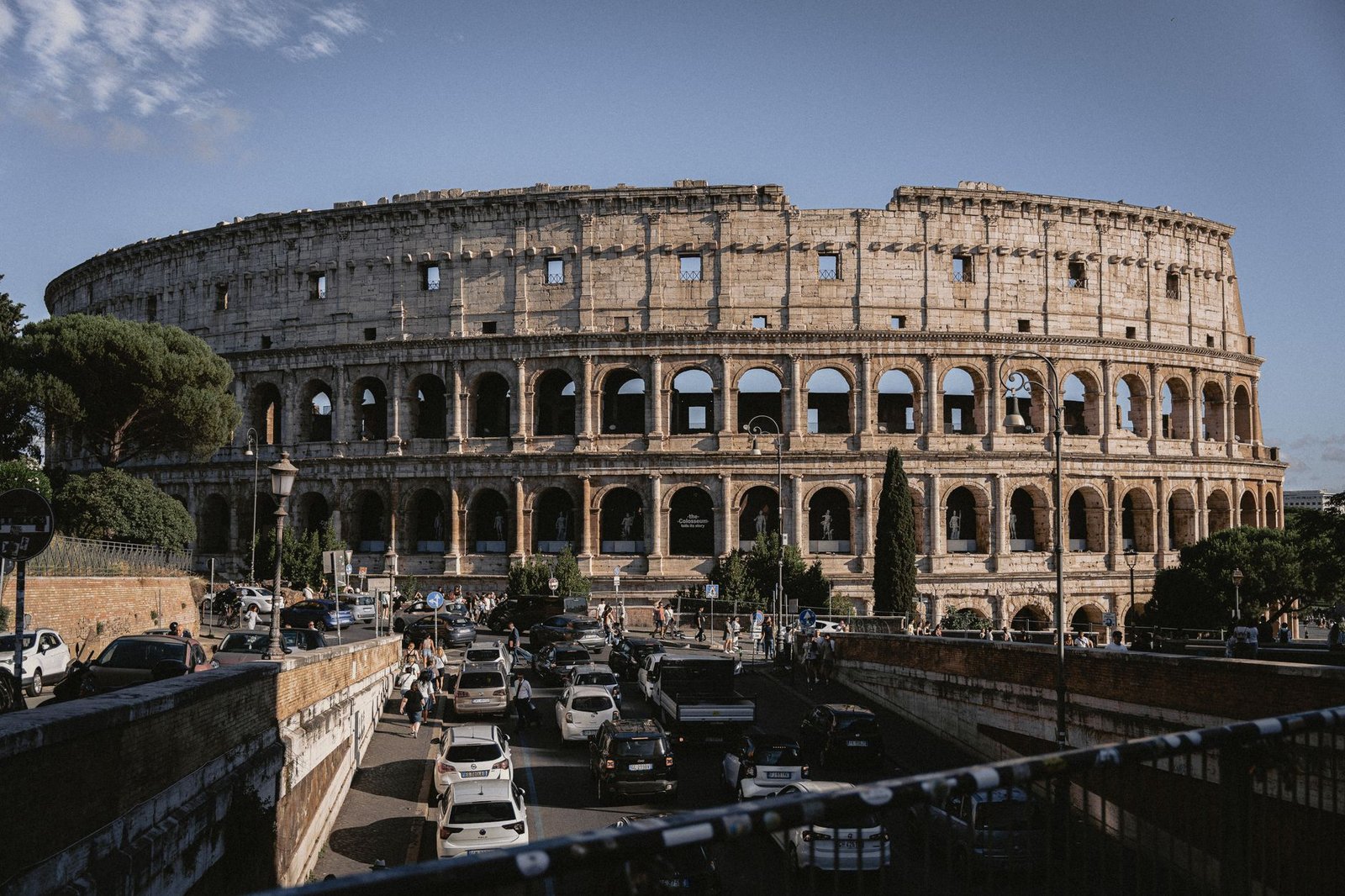 Ancient Roman Colosseum in Rome, Italy, with traffic passing by nearby streets