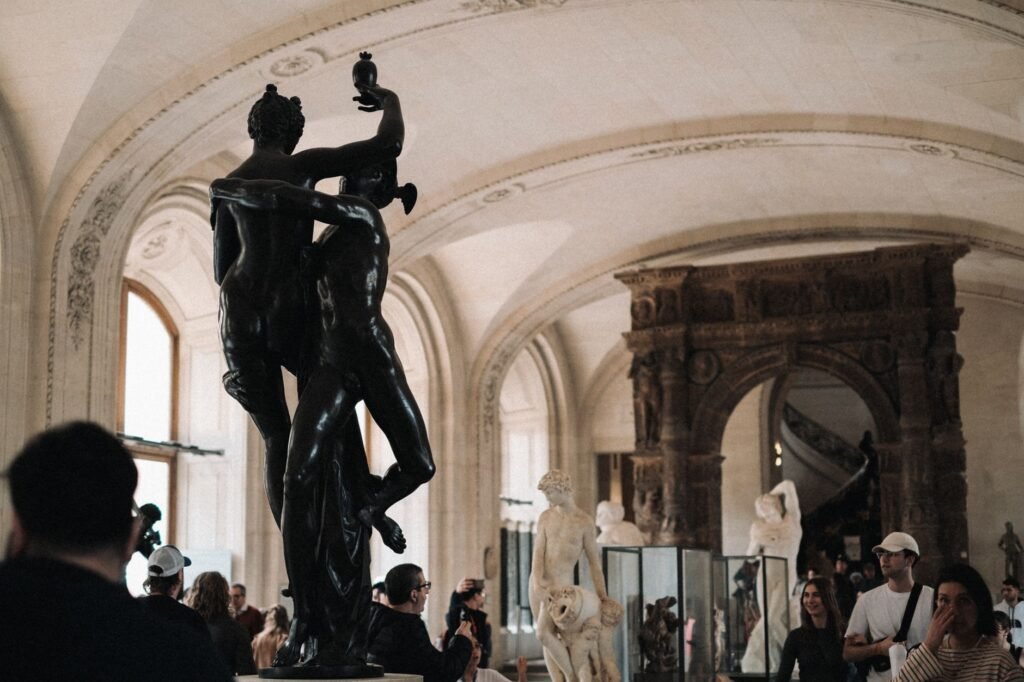 Museum interior with classical sculptures and visitors, evoking Mercury’s winged sandals mythological guide