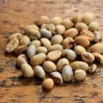Close-up of raw soybeans scattered on a wooden surface